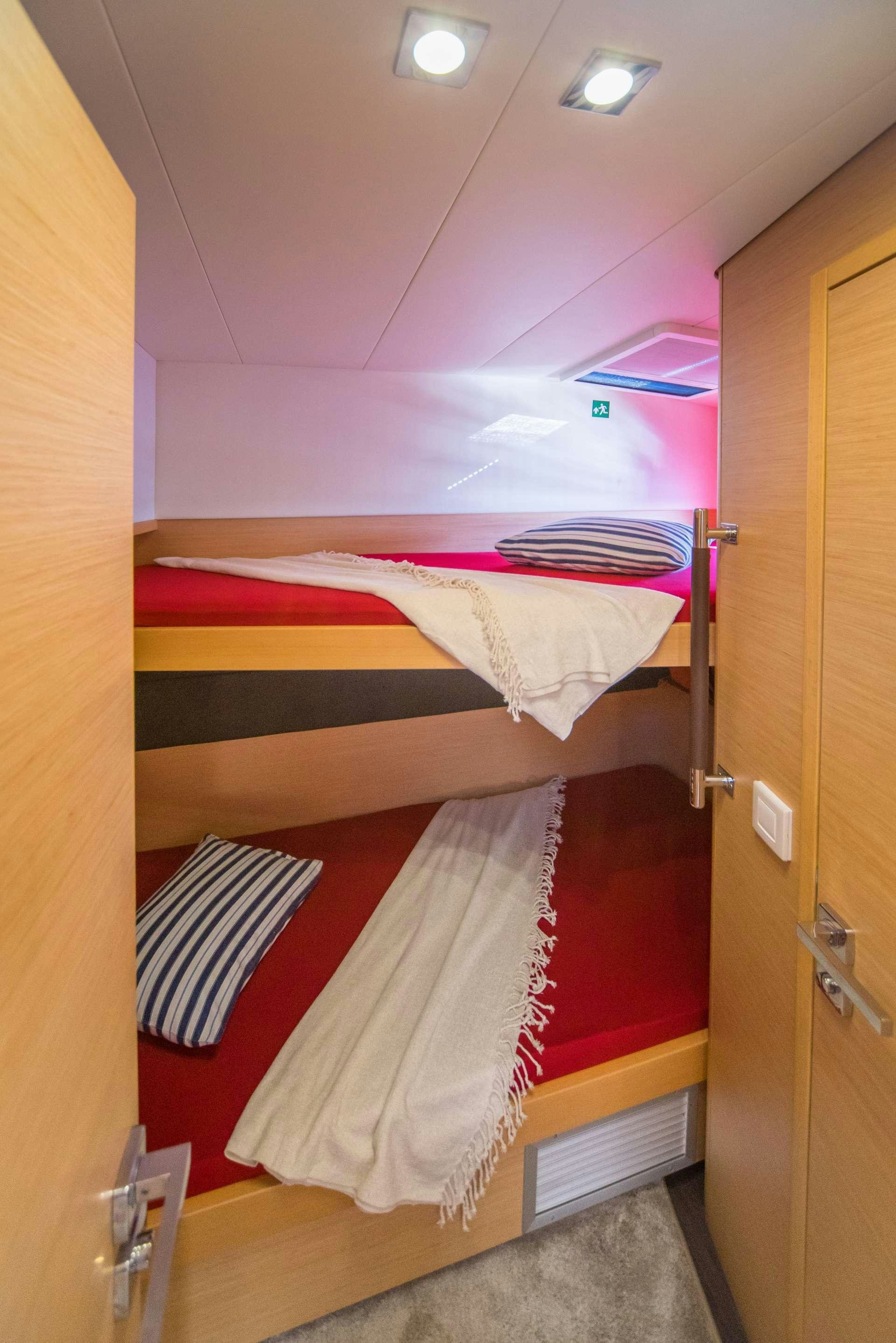 a room with a bed and a door aboard Pura Vida Yacht for Charter