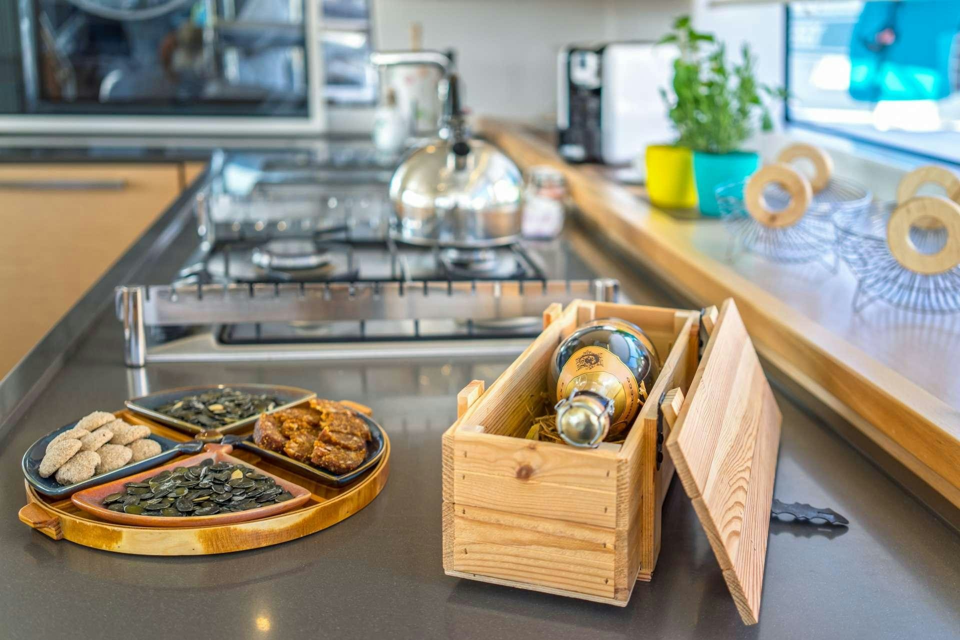 a kitchen counter with food and a robot aboard Pura Vida Yacht for Charter
