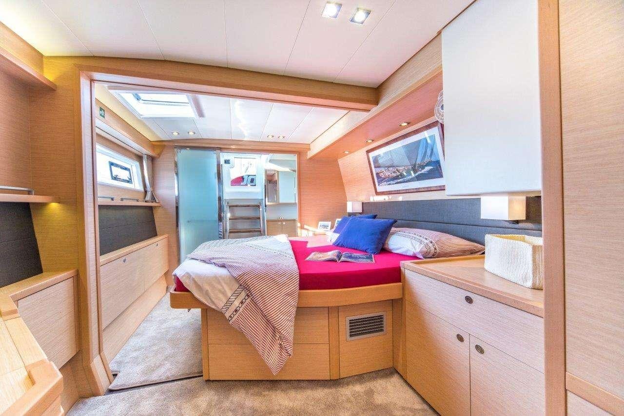 a bedroom with a bed and a desk aboard Pura Vida Yacht for Charter
