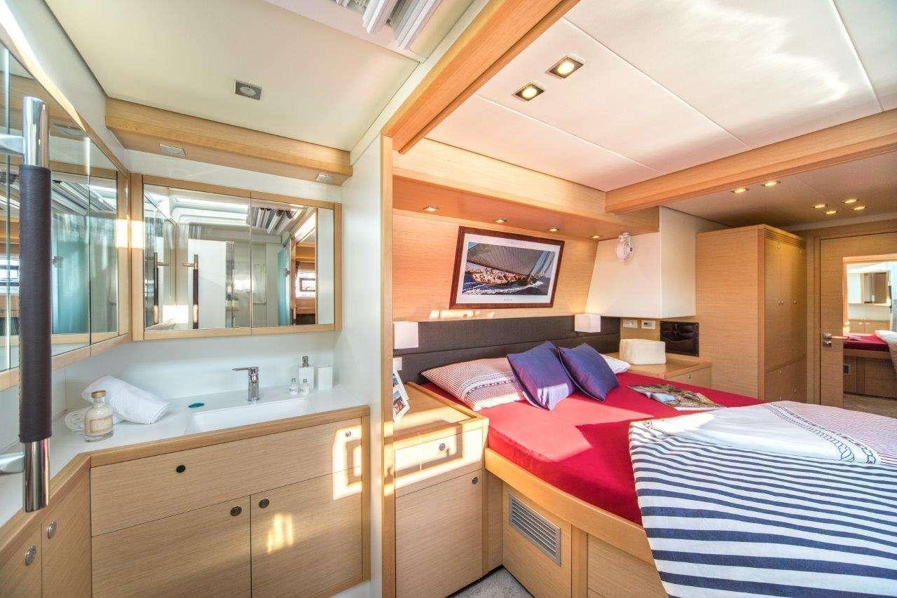 a bedroom with a double bed aboard Pura Vida Yacht for Charter
