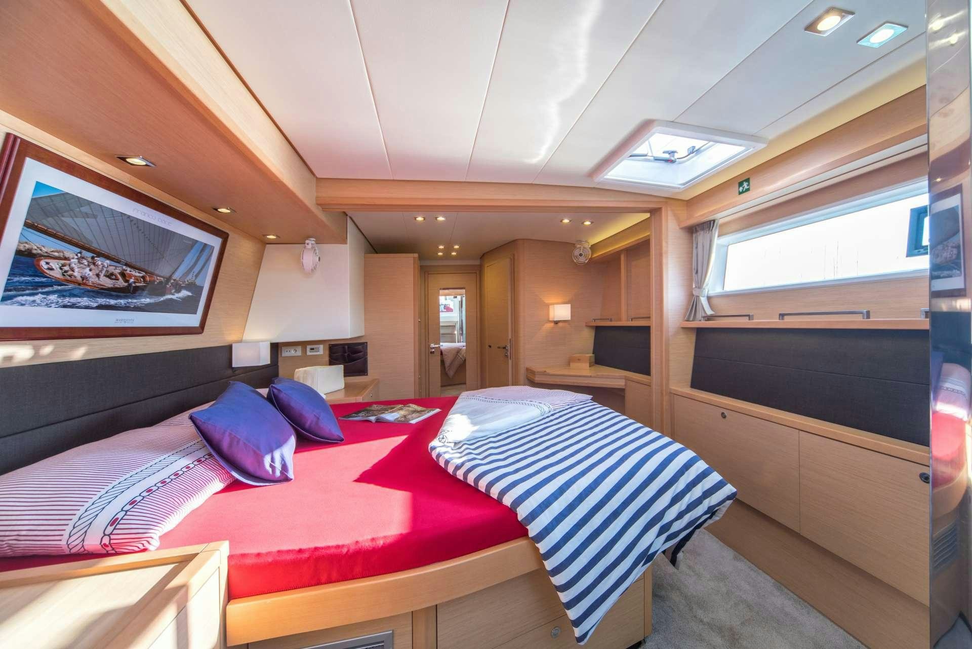 a room with a bed and a window aboard Pura Vida Yacht for Charter