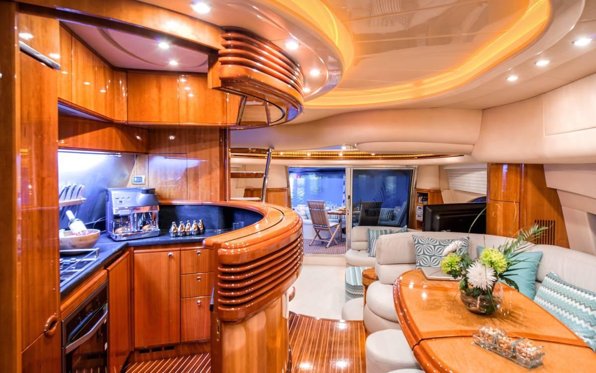 a kitchen with a bar and a table aboard MANU Yacht for Charter