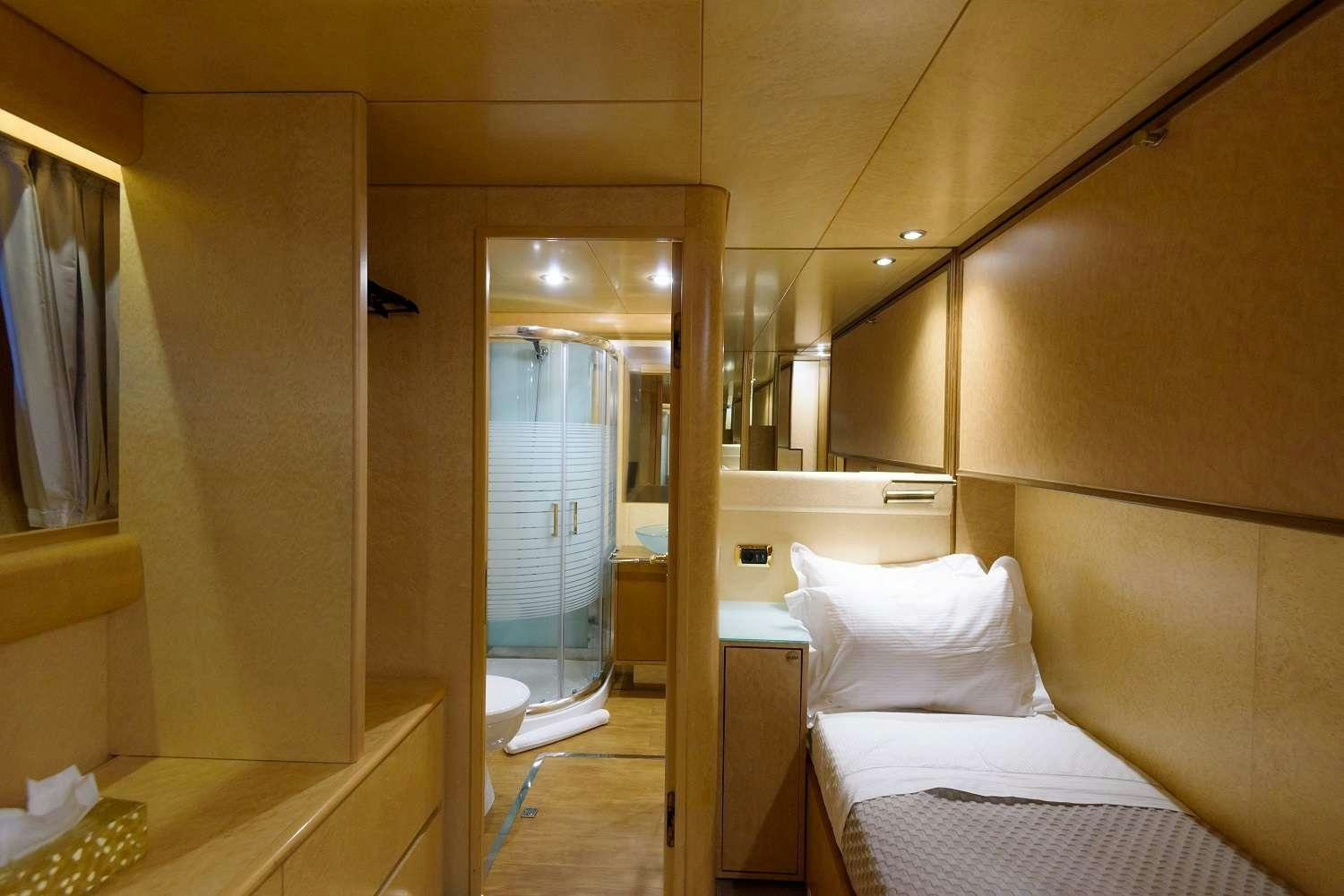 a room with a bed and a mirror aboard LADY RINA Yacht for Charter