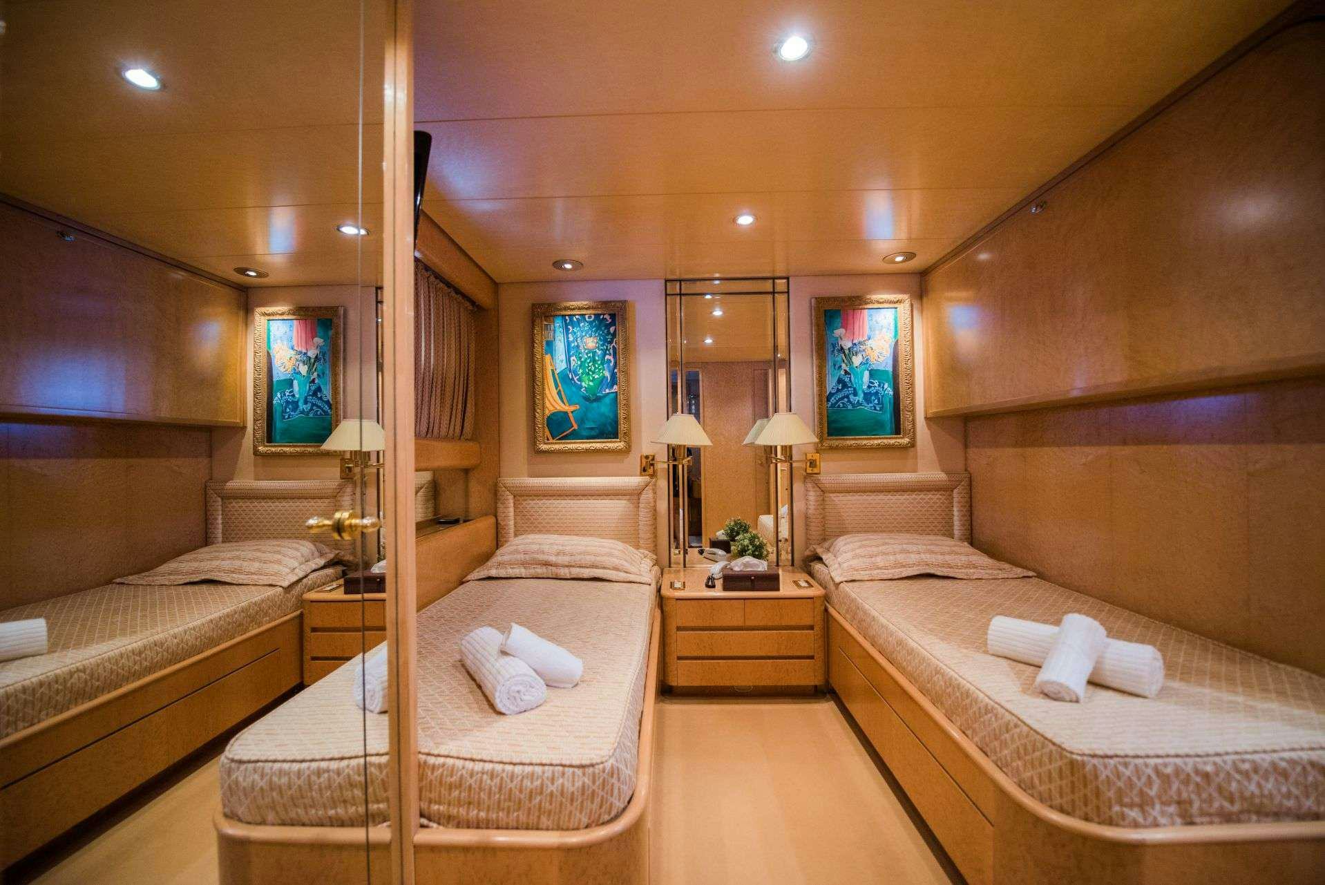 a room with a bed and a mirror aboard LADY RINA Yacht for Charter