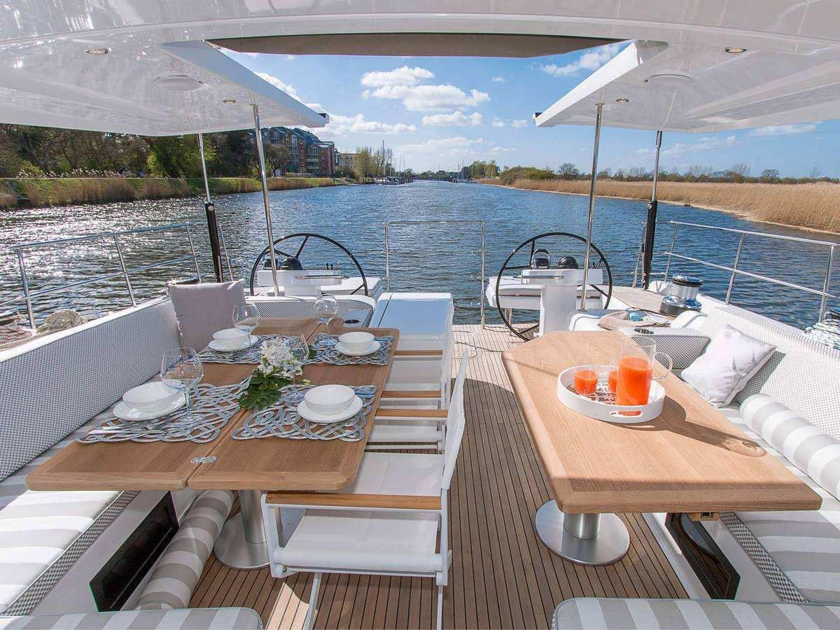 a table with plates and cups on it aboard ALIZEE Yacht for Charter