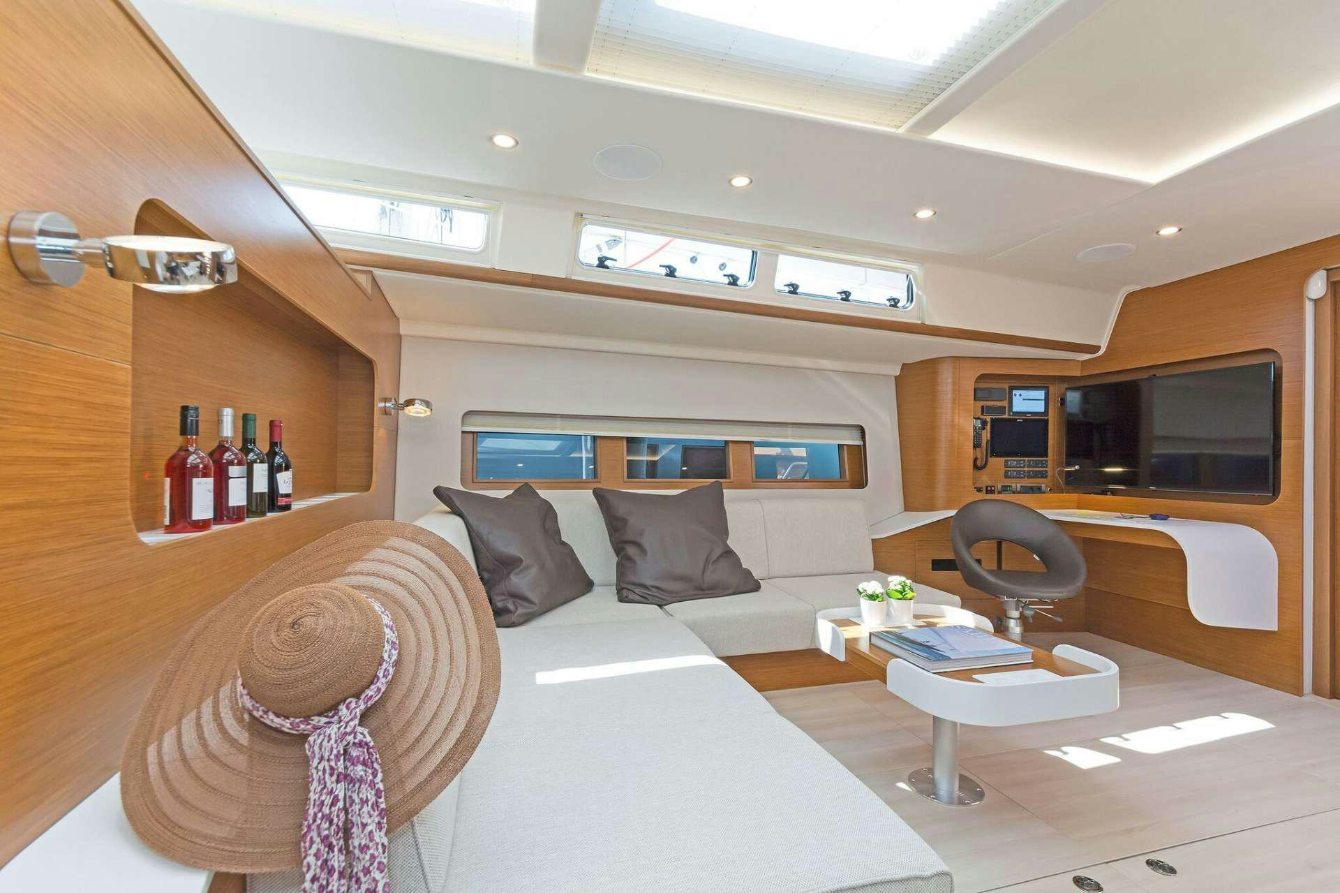 a room with a bed and a table aboard ALIZEE Yacht for Charter