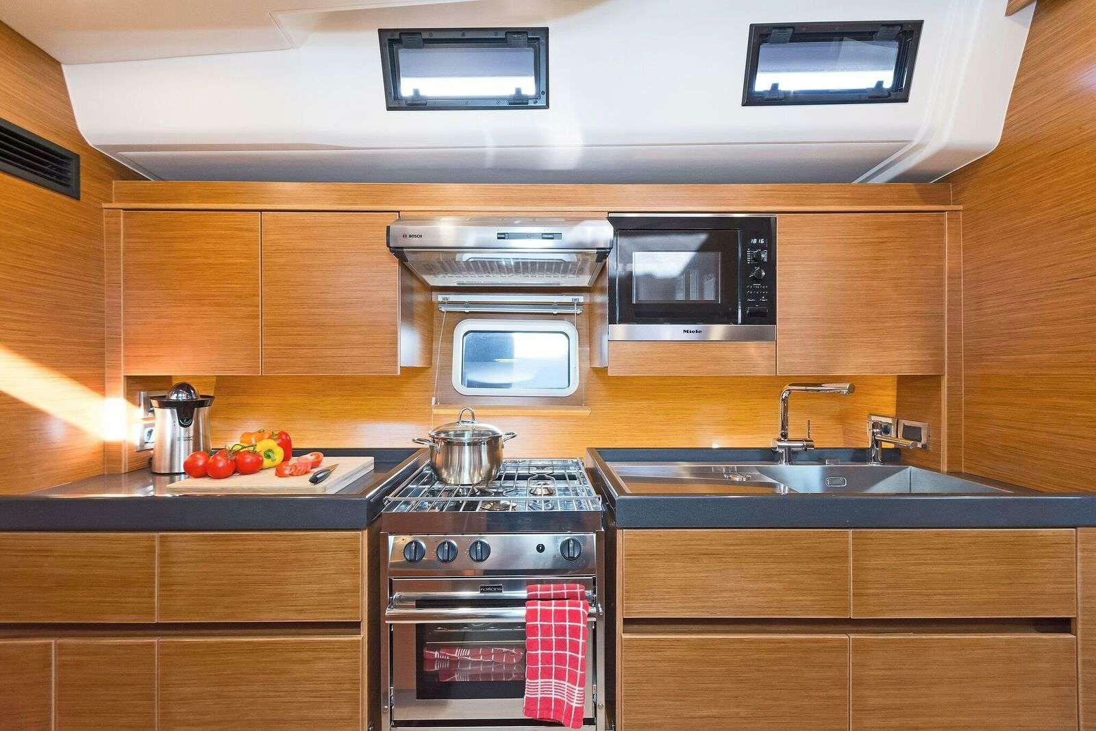 a kitchen with a stove and microwave aboard ALIZEE Yacht for Charter