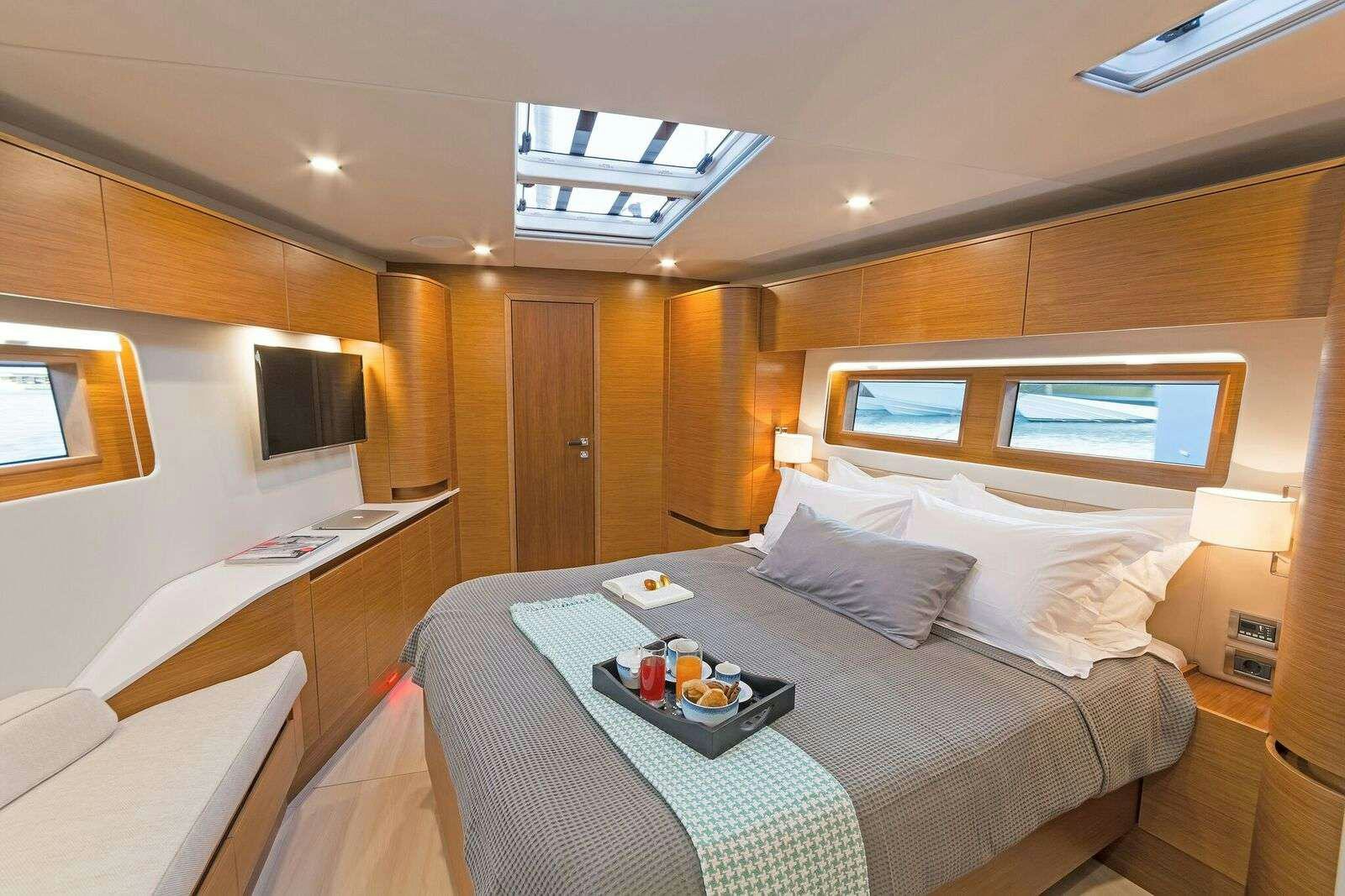 a hotel room with a bed and a desk aboard ALIZEE Yacht for Charter