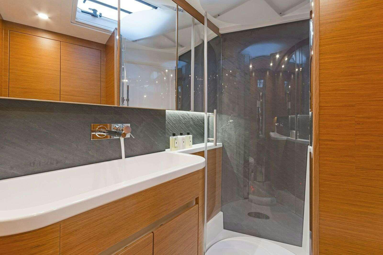 a bathroom with a glass shower aboard ALIZEE Yacht for Charter