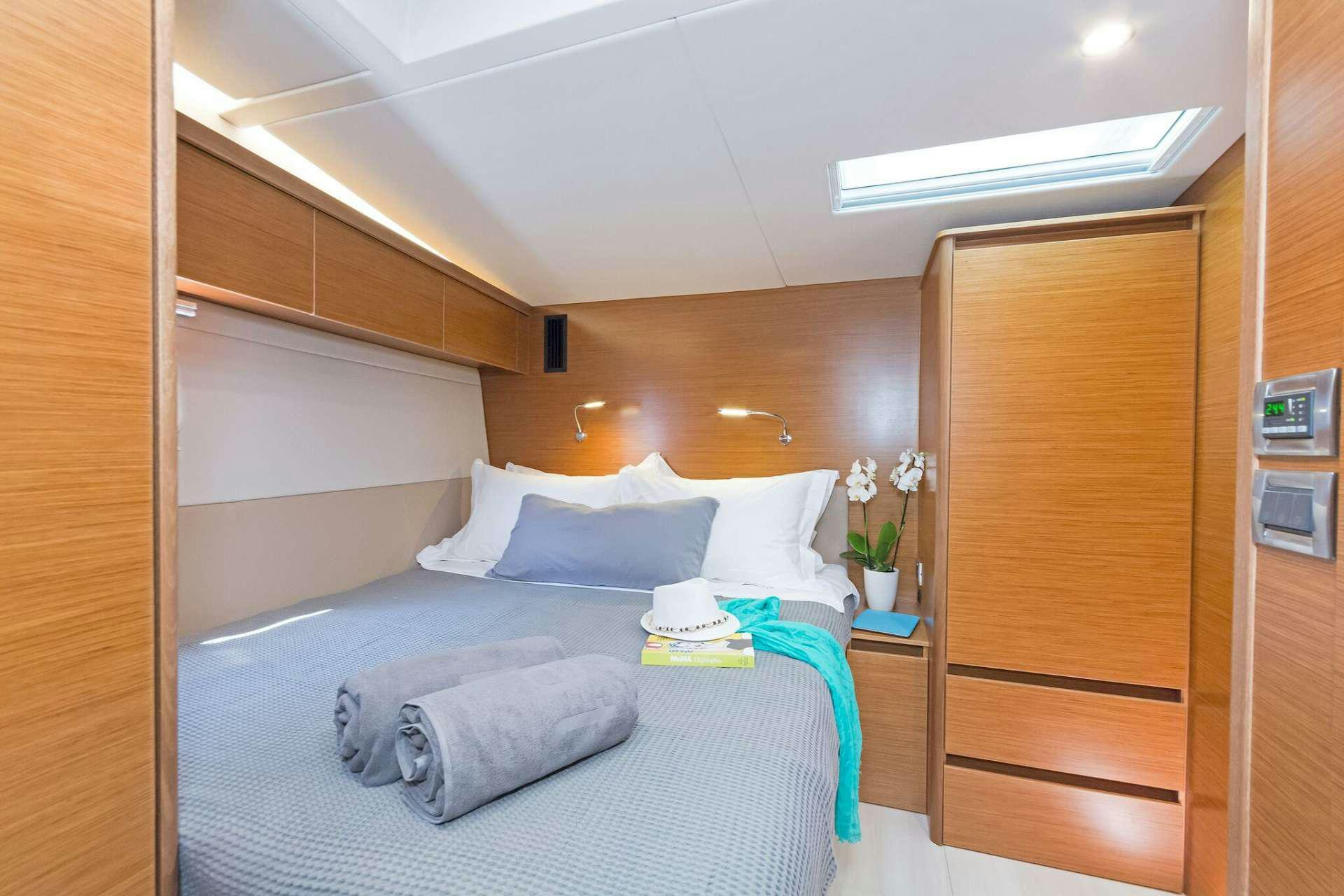 a bed with a white pillow aboard ALIZEE Yacht for Charter