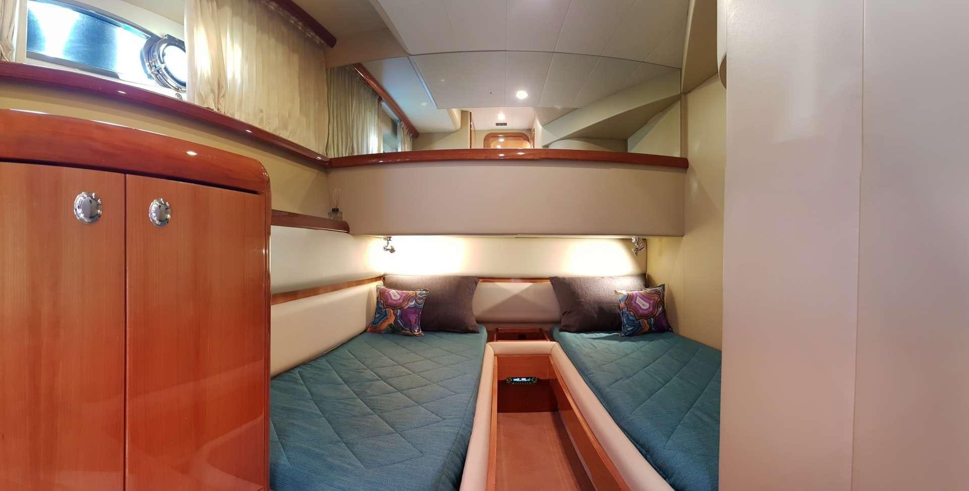 a room with a bed and a desk aboard ESPERANCE III Yacht for Charter