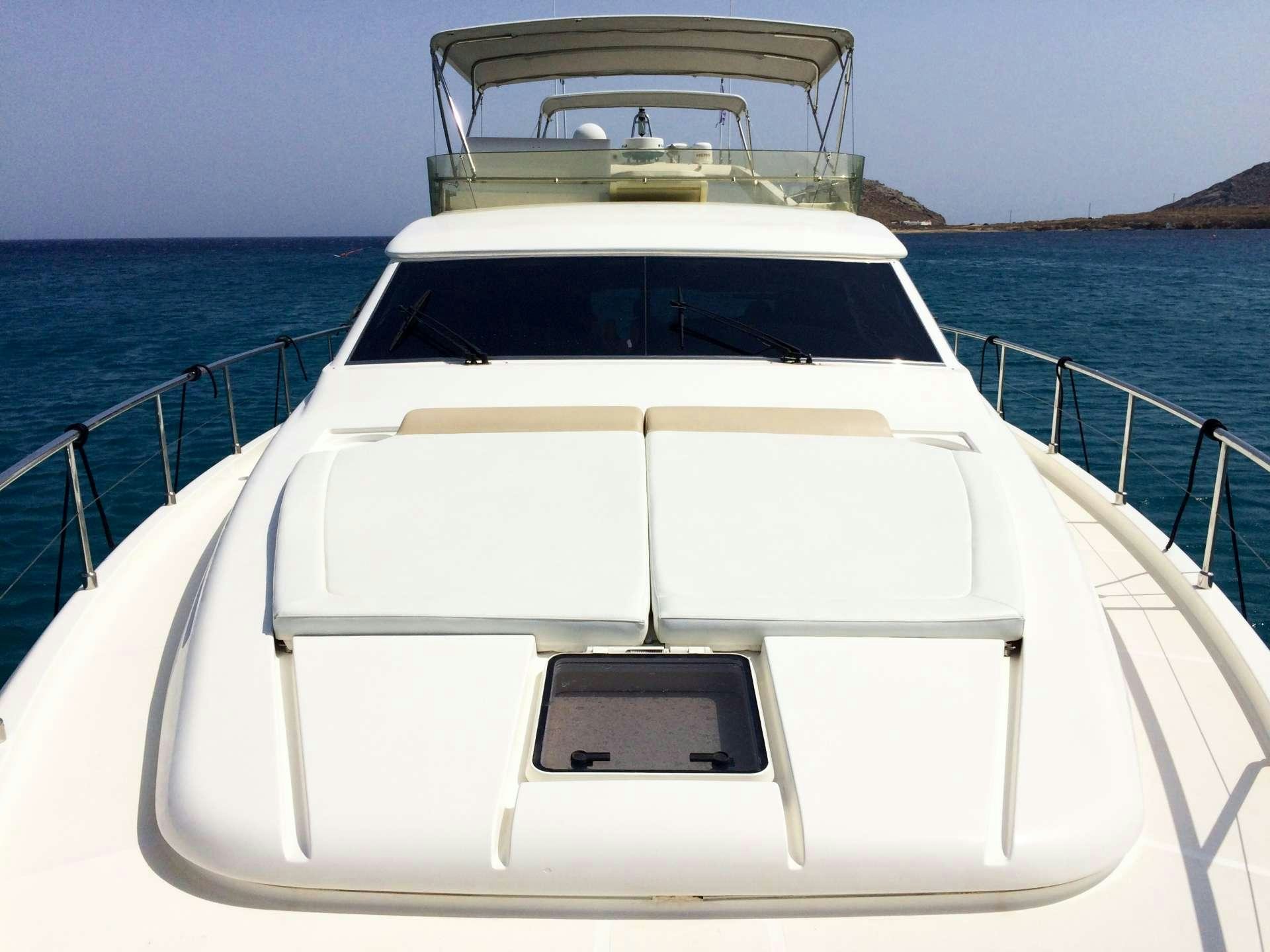 a white boat on a body of water aboard ESPERANCE III Yacht for Charter