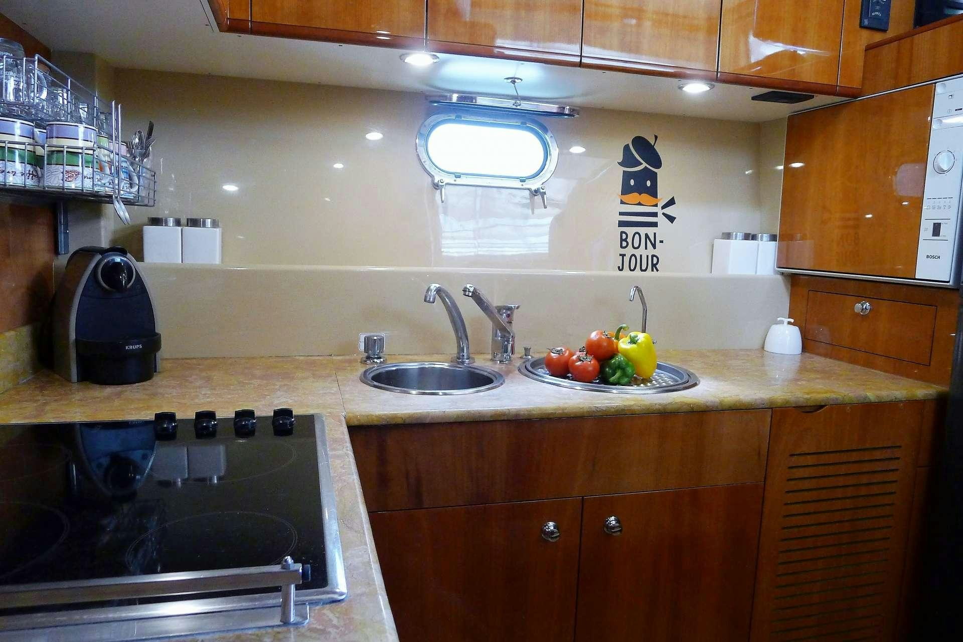 a kitchen with wooden cabinets aboard ESPERANCE III Yacht for Charter