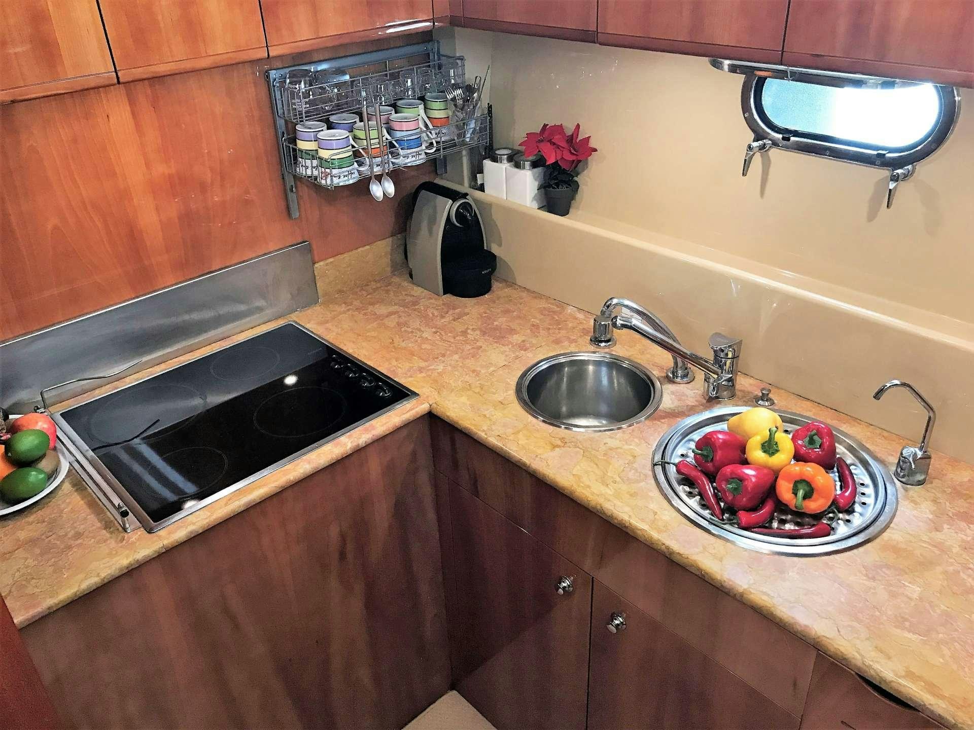 a kitchen with a bowl of fruit on a table aboard ESPERANCE III Yacht for Charter