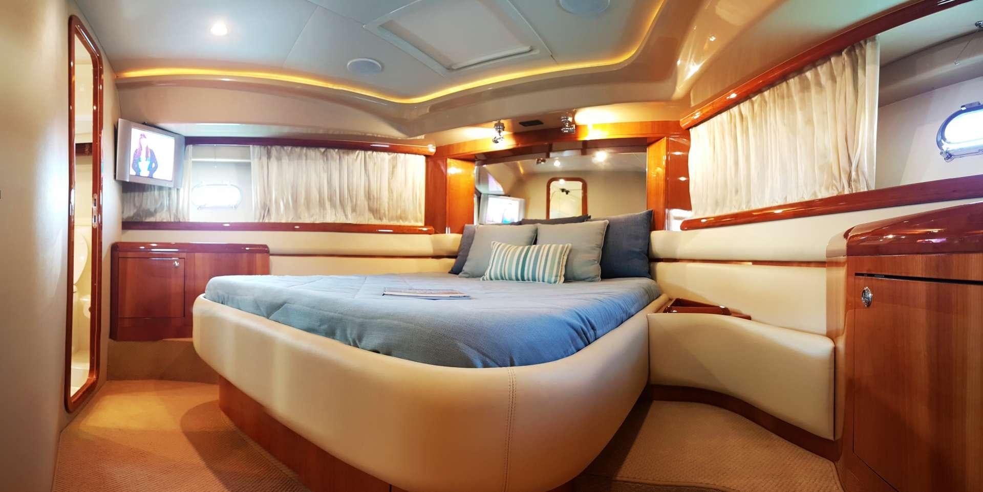 a room with a bed and a desk aboard ESPERANCE III Yacht for Charter