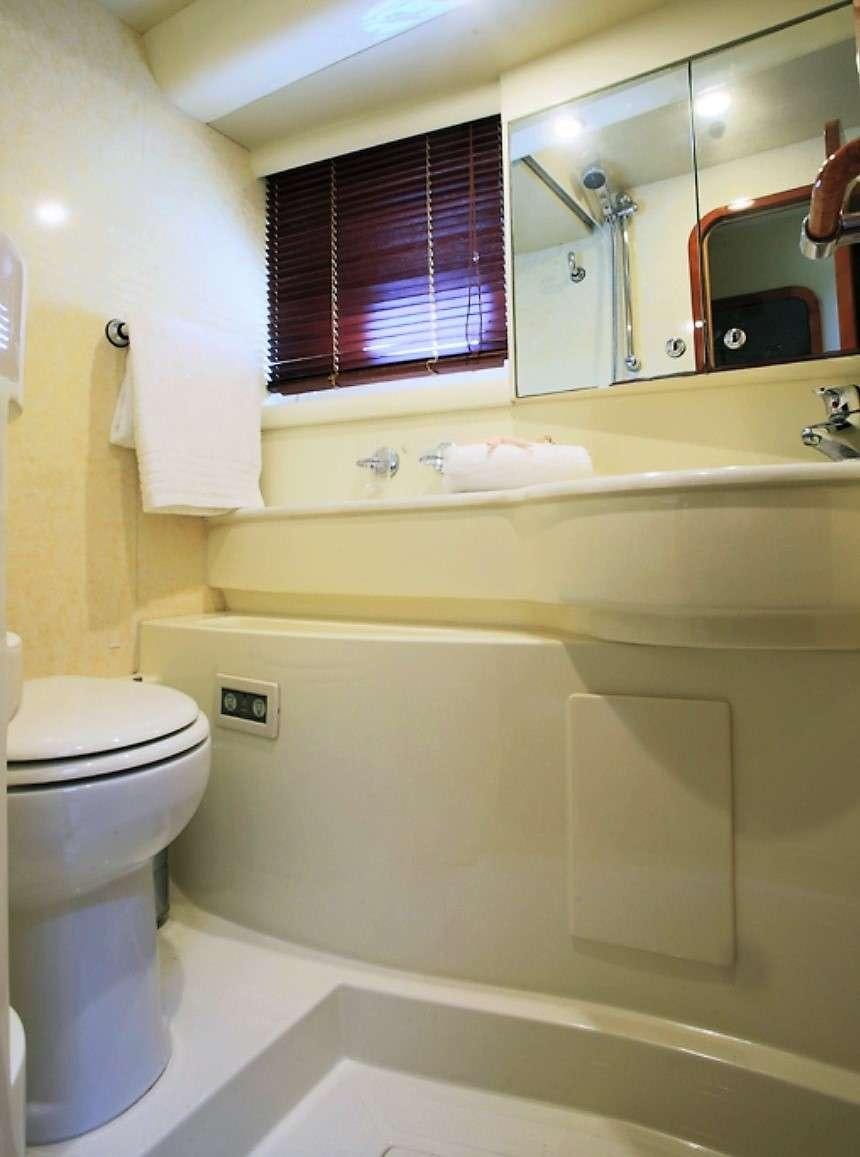 a bathroom with a toilet and a sink aboard ESPERANCE III Yacht for Charter