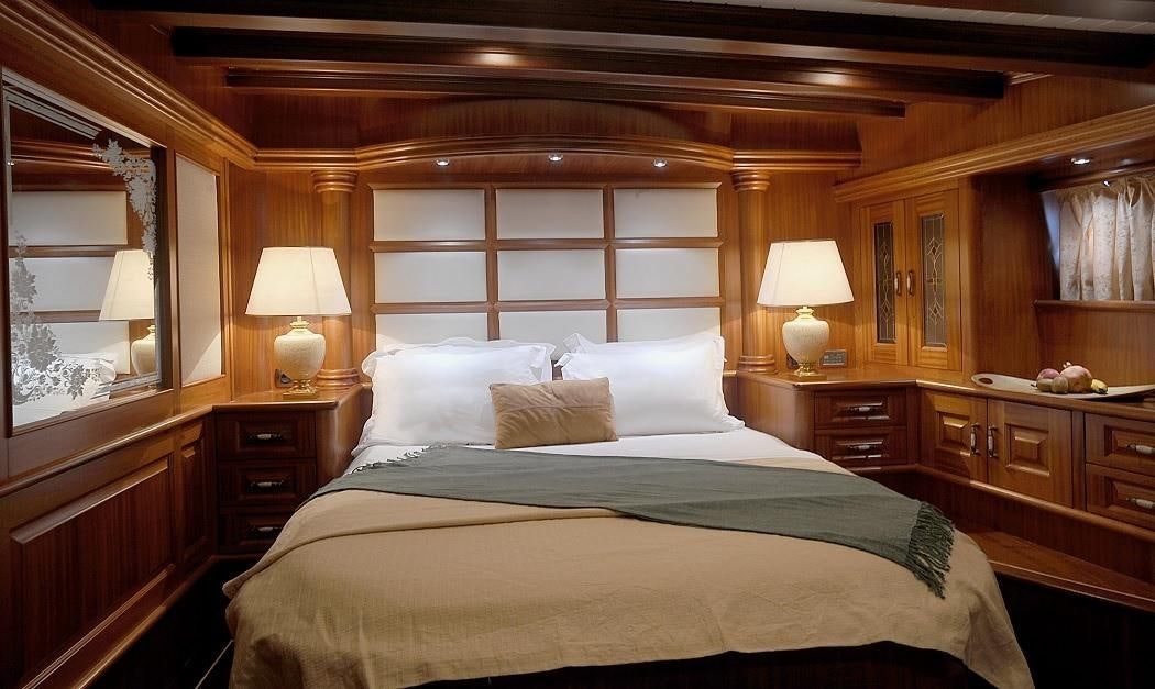 a bed with lamps on either side of it aboard KAPTAN KADIR Yacht for Charter