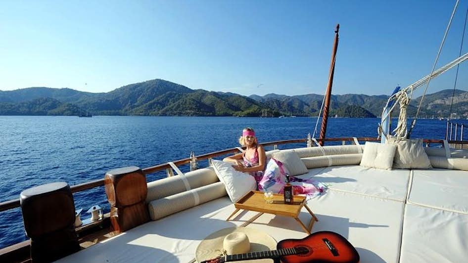 a person sitting on a boat aboard KAPTAN KADIR Yacht for Charter