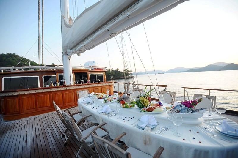 a table set for a meal on a boat aboard KAPTAN KADIR Yacht for Charter