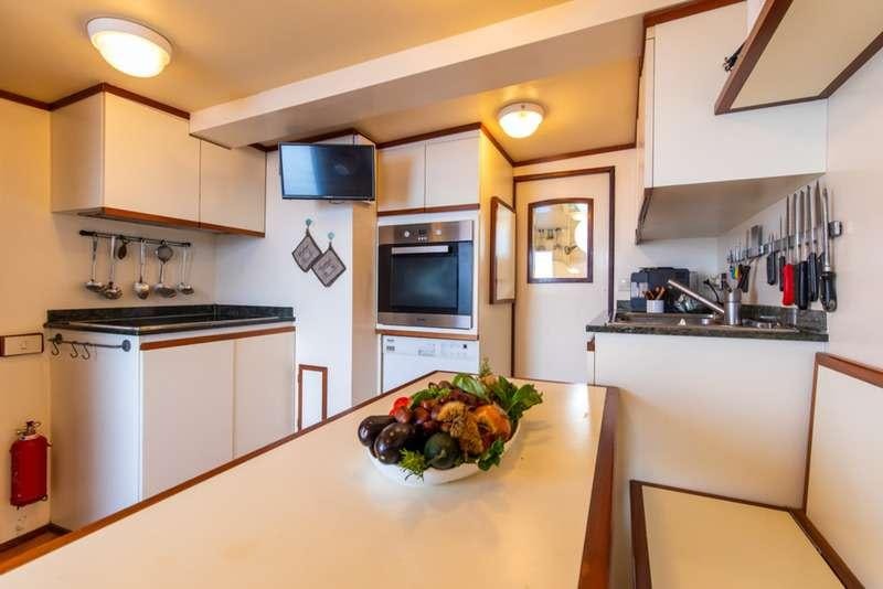 a kitchen with white cabinets aboard DP MONITOR Yacht for Charter