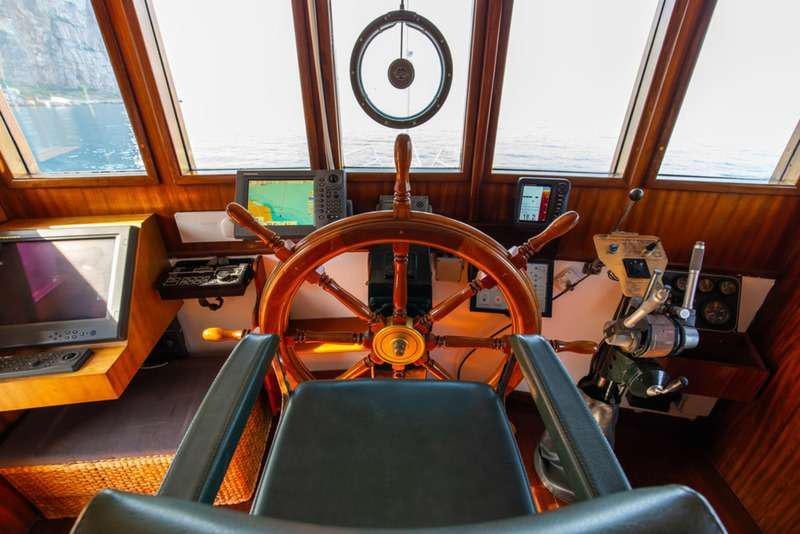 a room with a large wheel aboard DP MONITOR Yacht for Charter