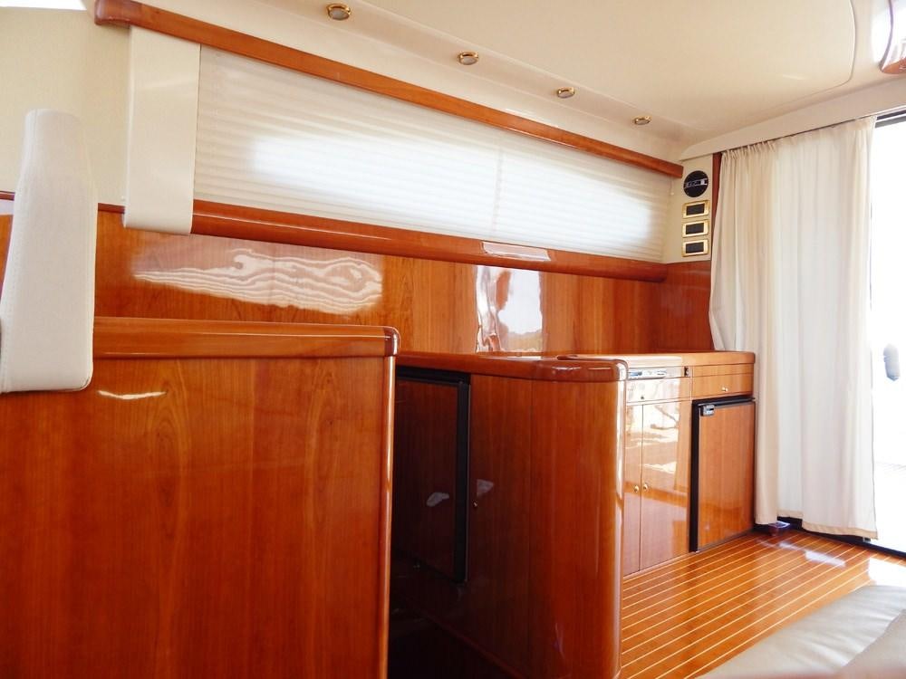 a room with wooden cabinets aboard SHINE Yacht for Charter