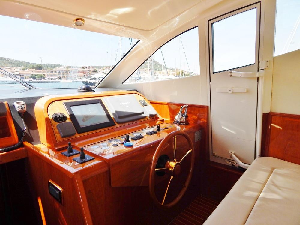 a room with a desk and a laptop on a table aboard SHINE Yacht for Charter