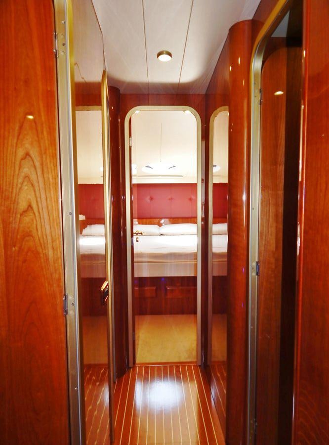 a hallway with a wood door aboard SHINE Yacht for Charter