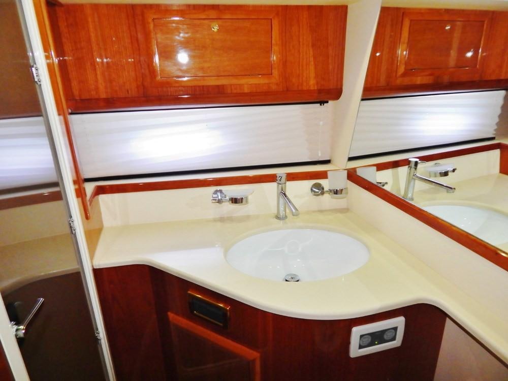 a bathroom with a sink and a mirror aboard SHINE Yacht for Charter