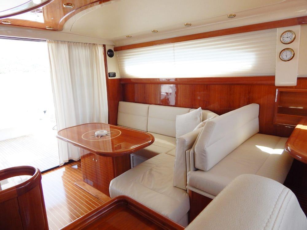 a living room with a table and couches aboard SHINE Yacht for Charter