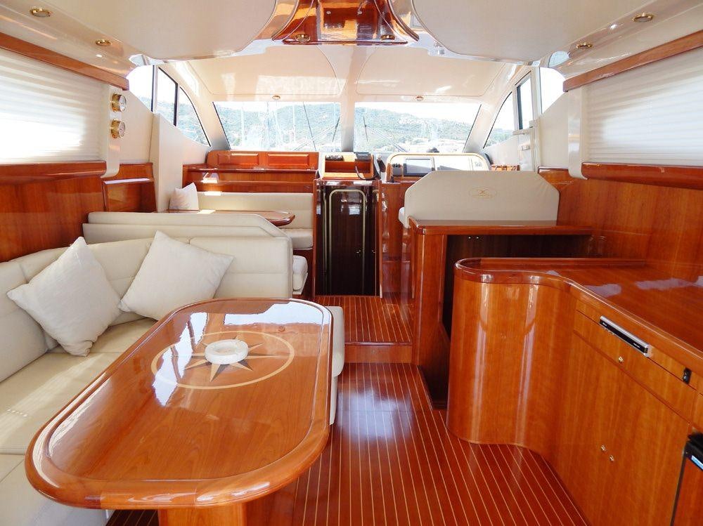 a room with a table and couch aboard SHINE Yacht for Charter