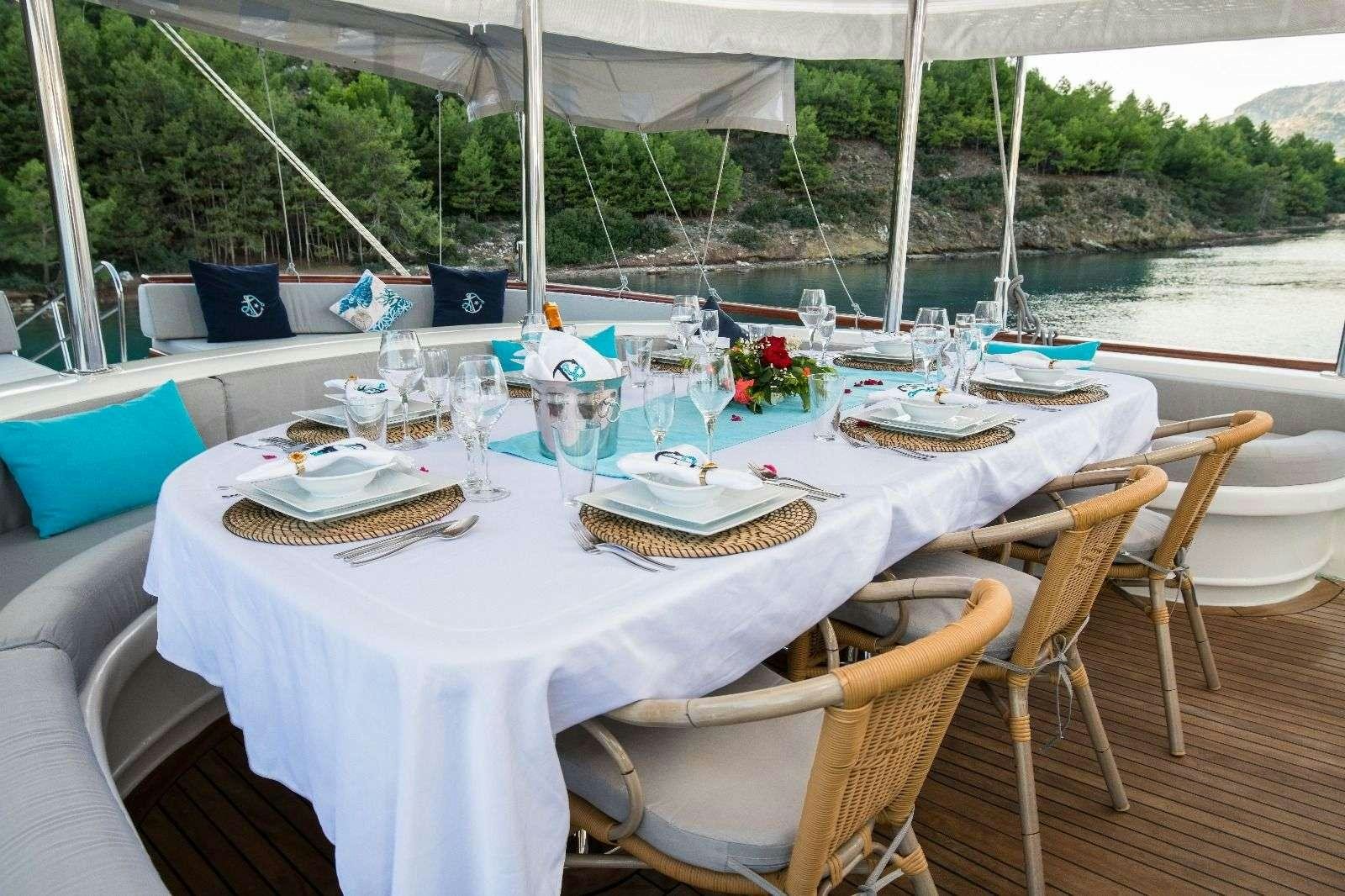 a table set for a dinner aboard VISTA MARE Yacht for Charter