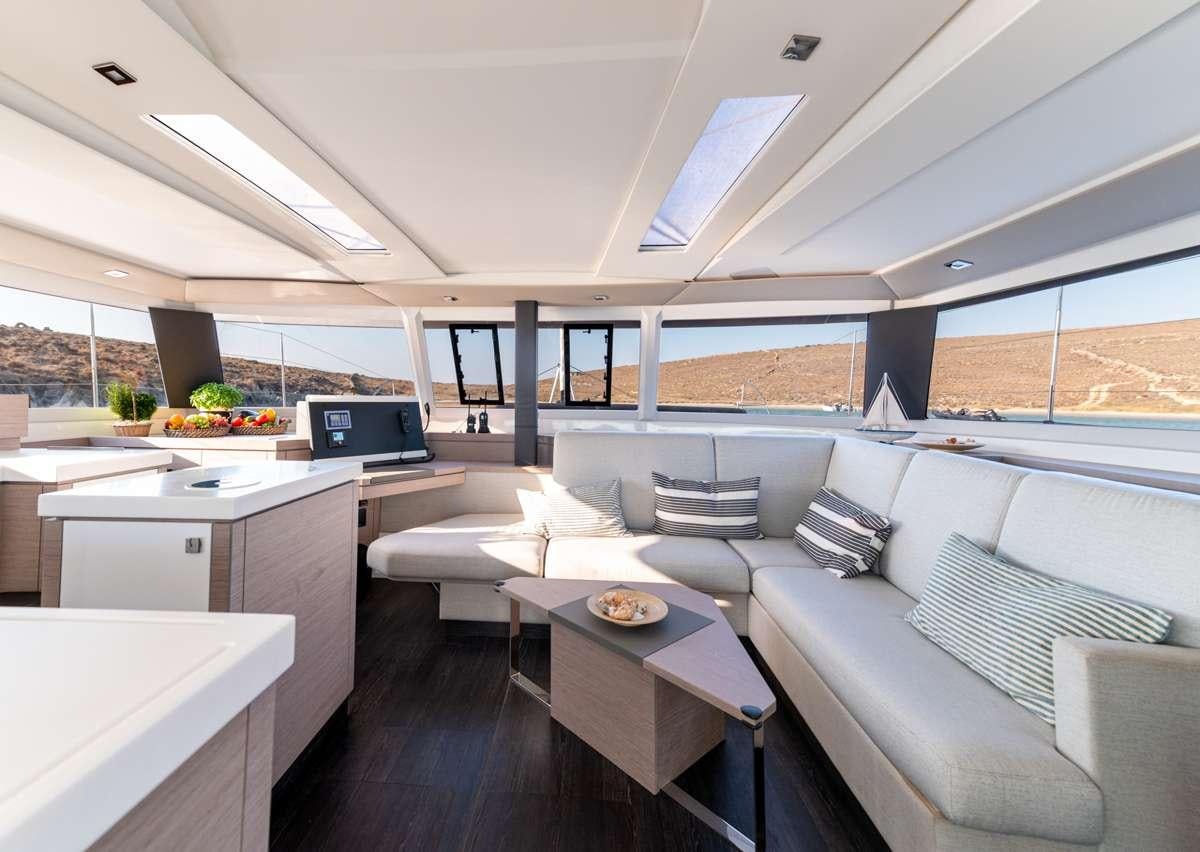 a living room with a couch and a laptop aboard WHITE CORAL Yacht for Charter