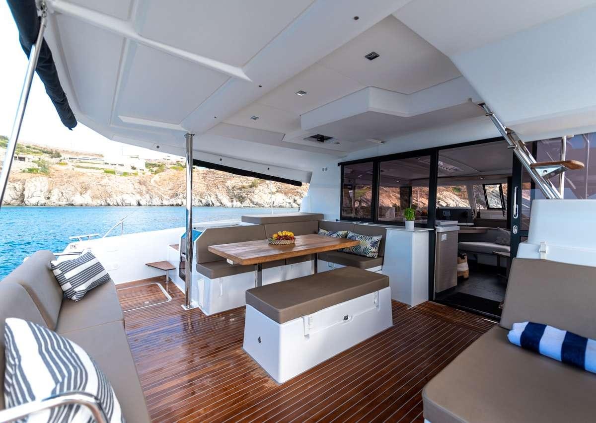 a room with a table and chairs aboard WHITE CORAL Yacht for Charter