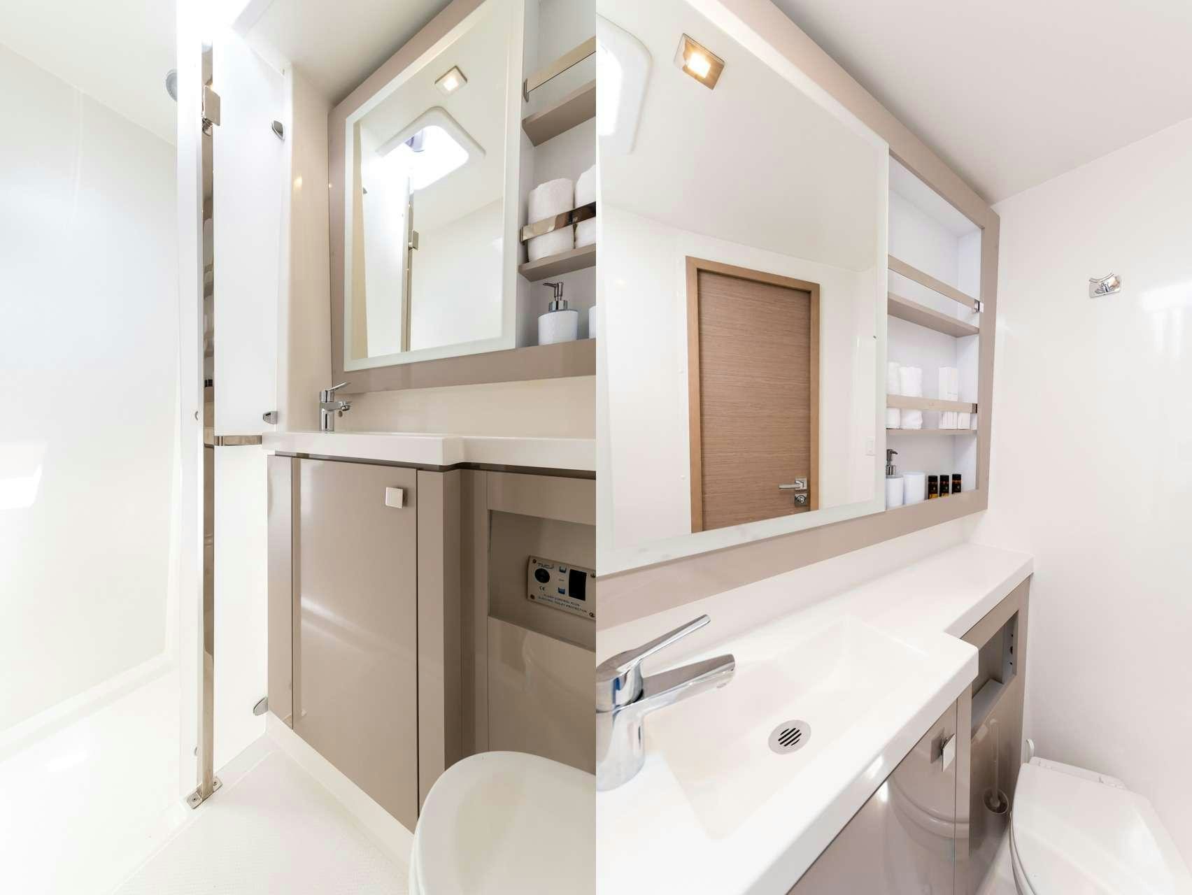 a bathroom with white cabinets aboard WHITE CORAL Yacht for Charter