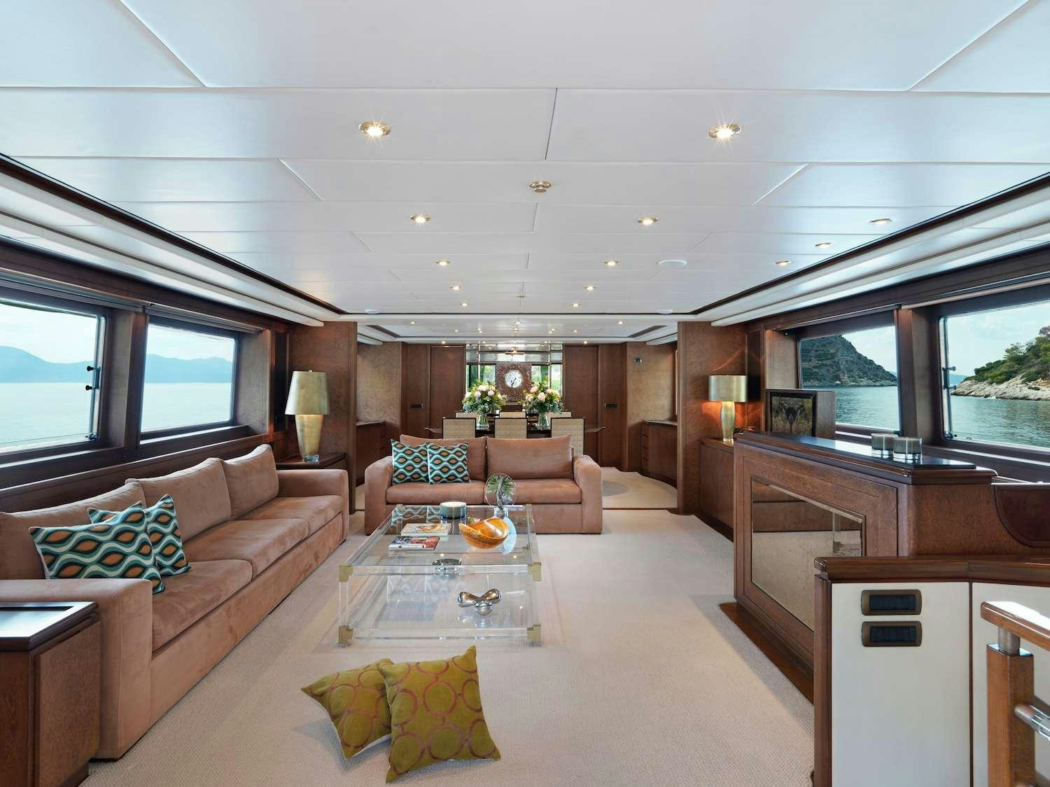 a living room with a couch and a table aboard IDYLLE Yacht for Charter