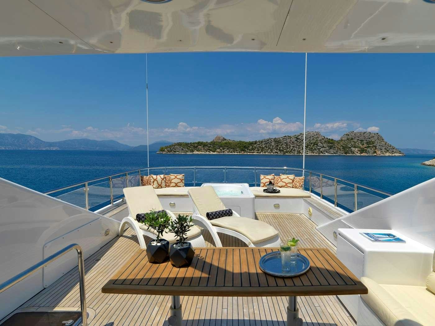 a balcony with a table and chairs aboard IDYLLE Yacht for Charter