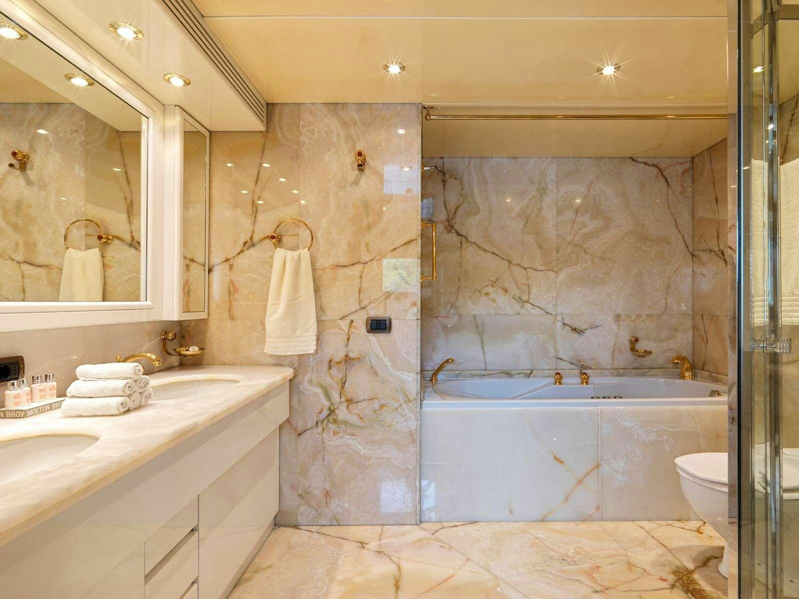 a bathroom with a bathtub and sink aboard IDYLLE Yacht for Charter