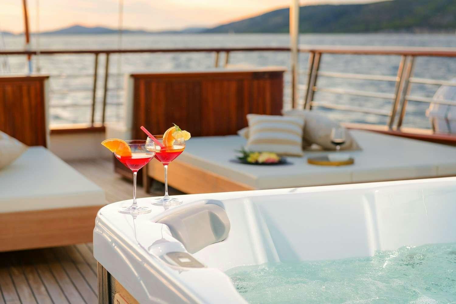 a pool with a table and chairs aboard SON DE MAR Yacht for Charter