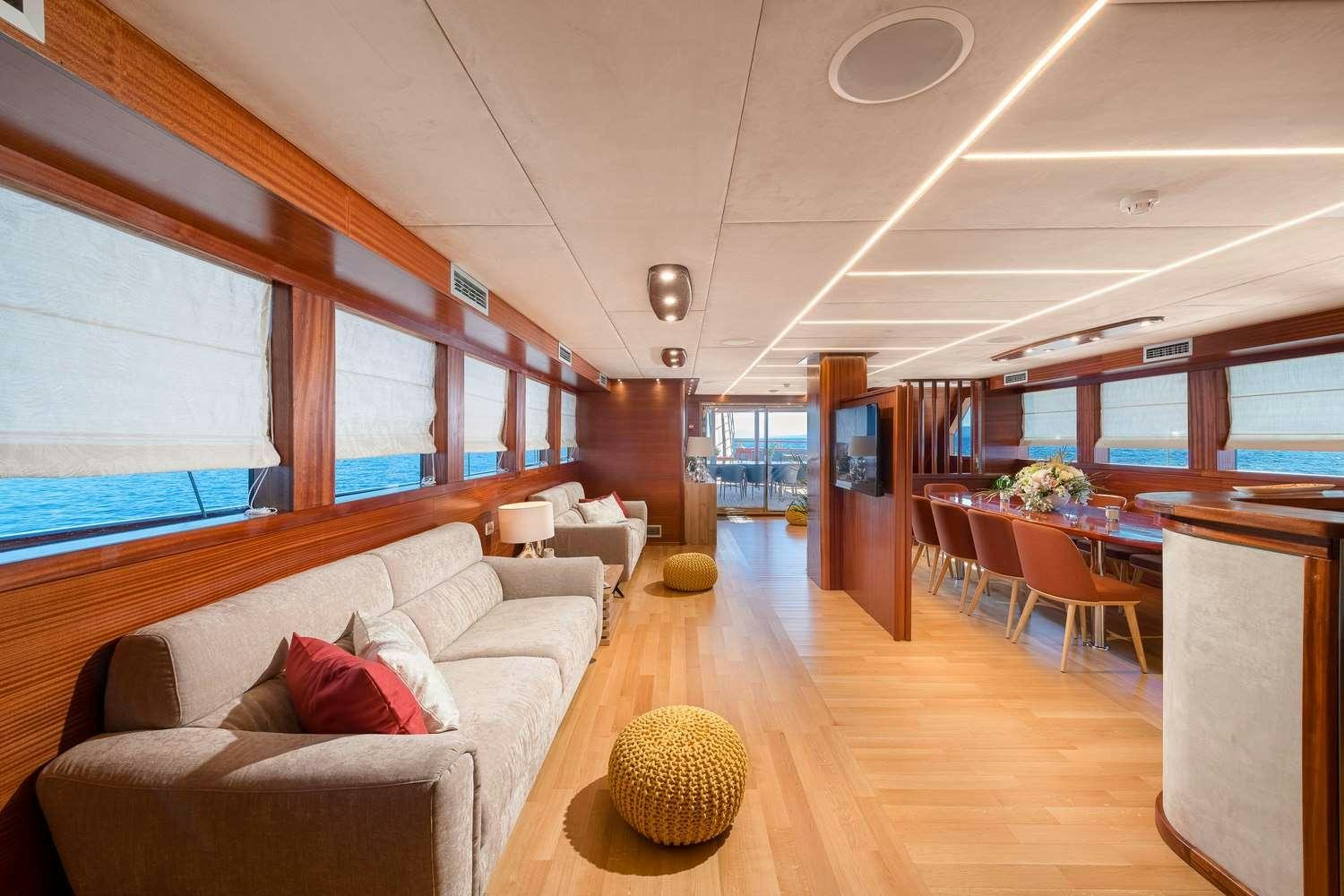a living room with a couch and a table aboard SON DE MAR Yacht for Charter