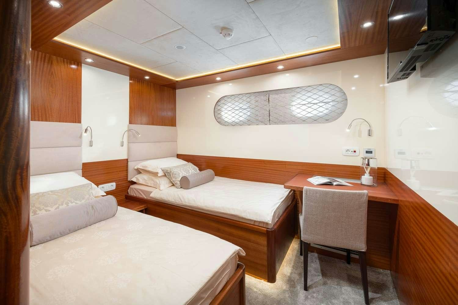 a room with a bed and a desk aboard SON DE MAR Yacht for Charter