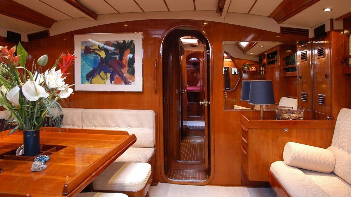 a room with a table and chairs aboard SHAITAN (65' SWAN) Yacht for Charter