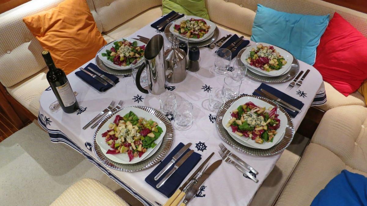 a table with food and wine aboard SHAITAN (65' SWAN) Yacht for Charter