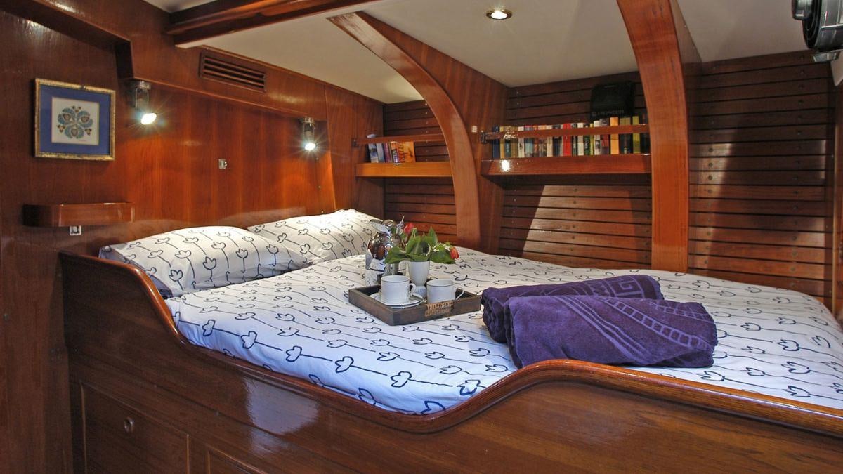 a bed with a tray on it aboard SHAITAN (65' SWAN) Yacht for Charter