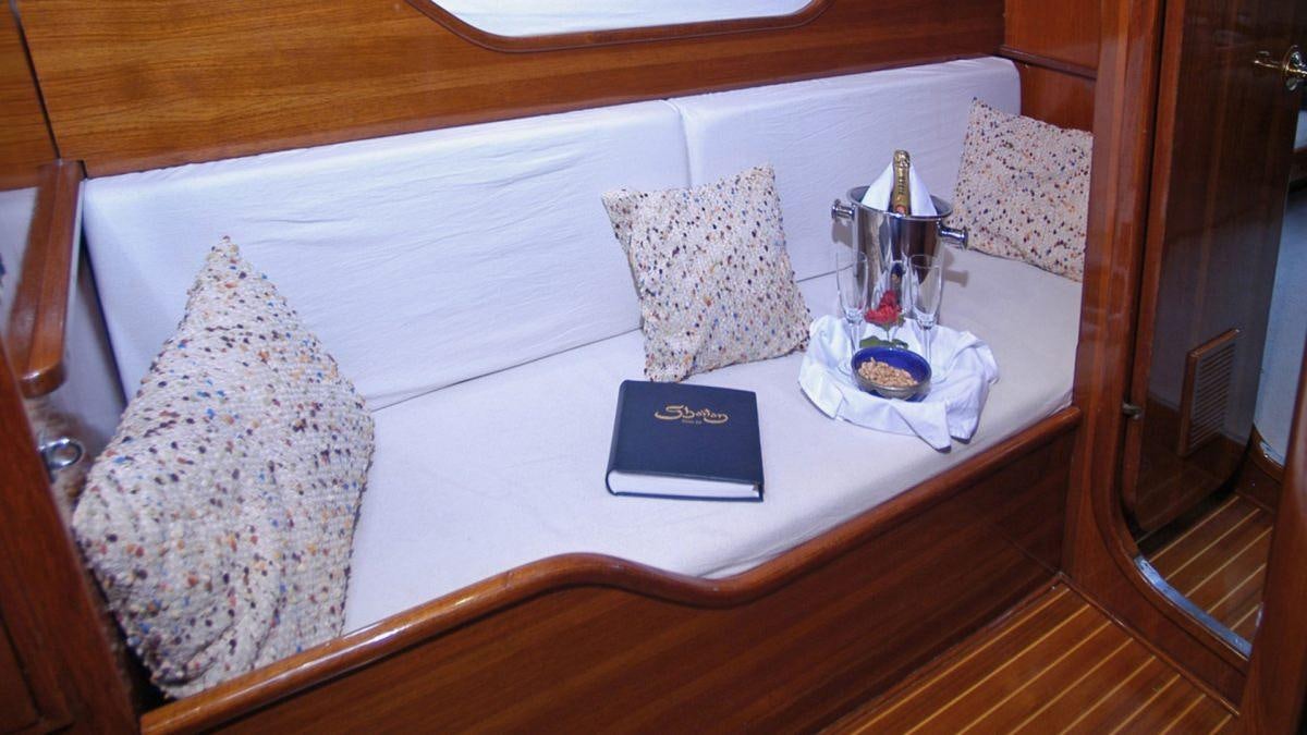 a table with a few pillows aboard SHAITAN (65' SWAN) Yacht for Charter