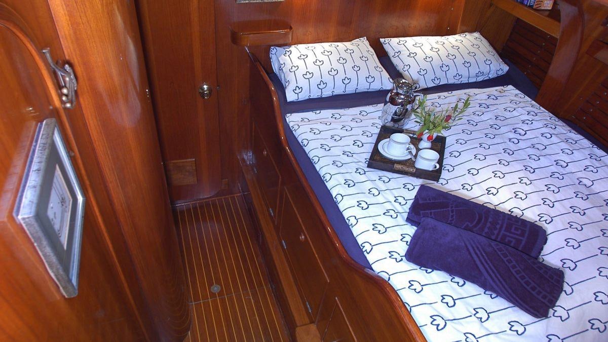 a table with a blue cloth on it and a flower on it aboard SHAITAN (65' SWAN) Yacht for Charter