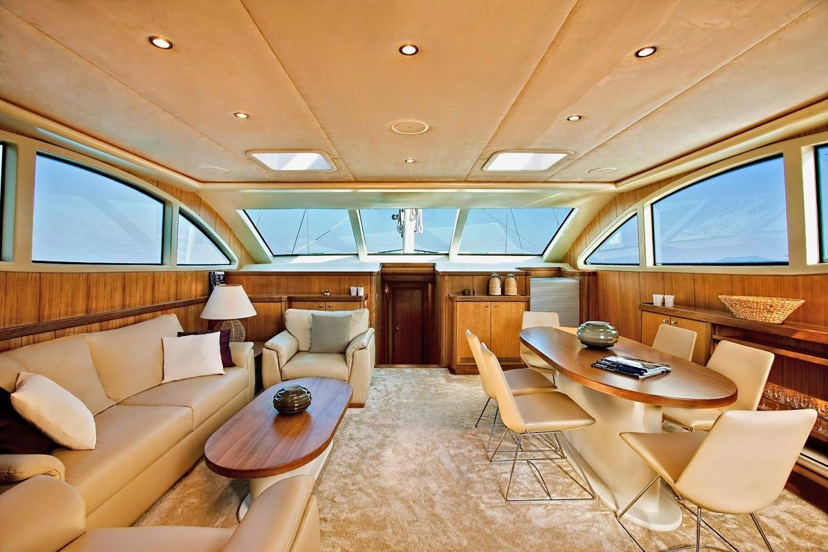 a living room with a table and chairs aboard MISS B Yacht for Charter
