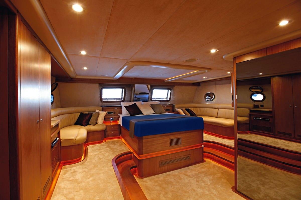 a room with a bed and a couch aboard MISS B Yacht for Charter