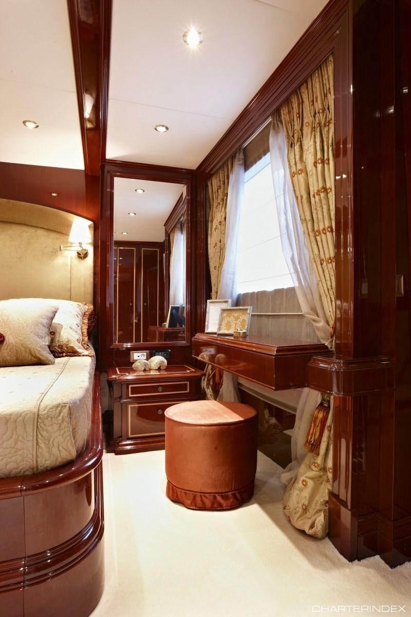 a bedroom with a bed and a desk aboard IRAKLIS L Yacht for Charter