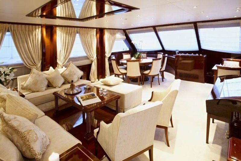 a room with a table chairs and a couch aboard IRAKLIS L Yacht for Charter